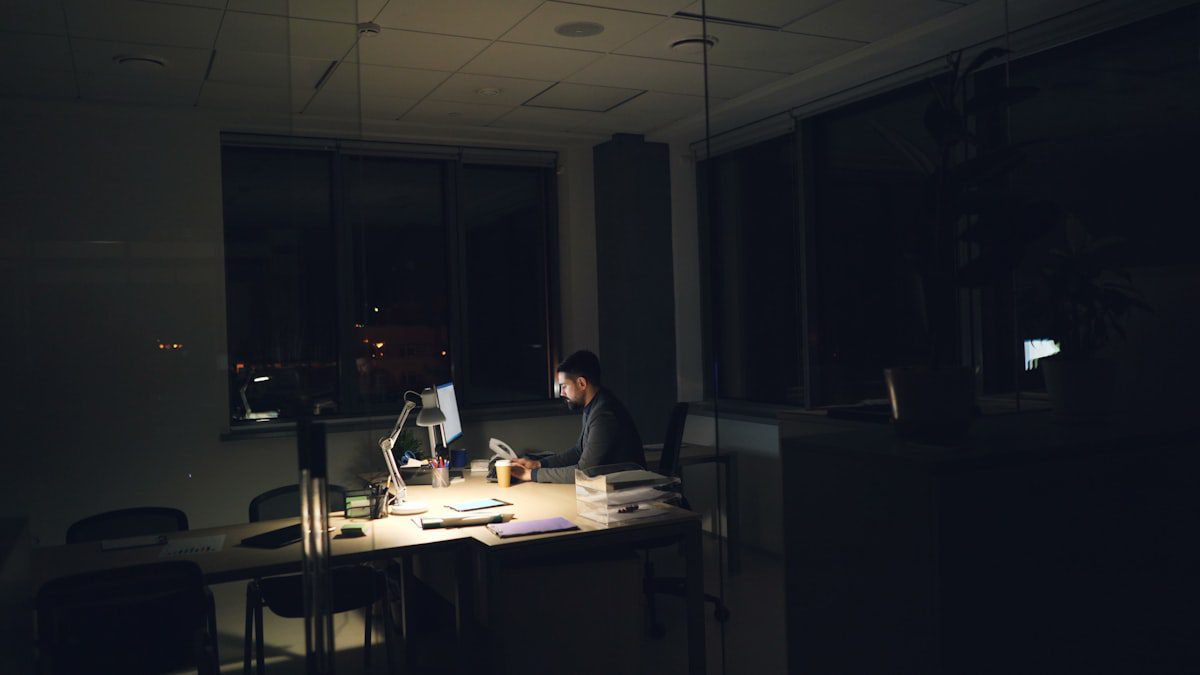 Professional working late at a desk, representing the careful analysis work of an AI agent safety researcher