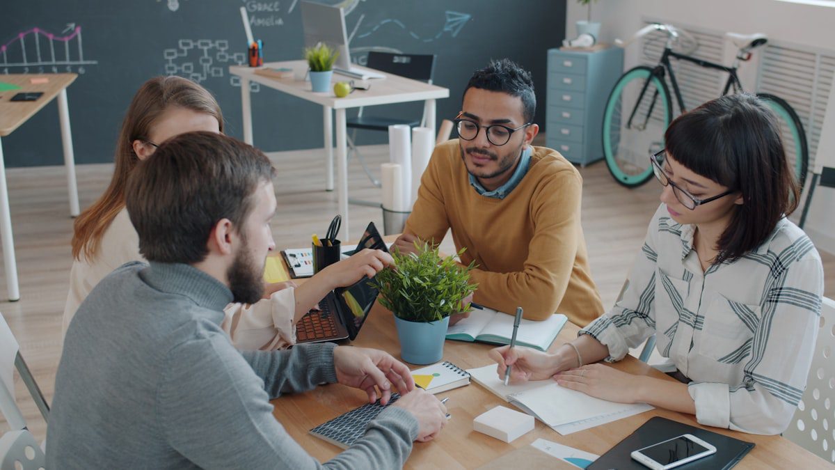Team mapping out an AI agent workflow on a whiteboard, illustrating the AI Agent Designer role