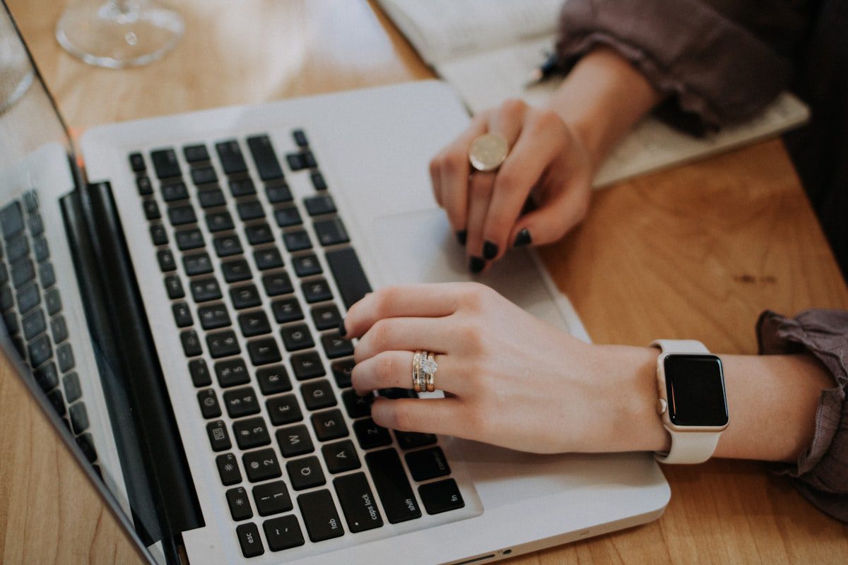 Person typing on a laptop to use AI to write a resume