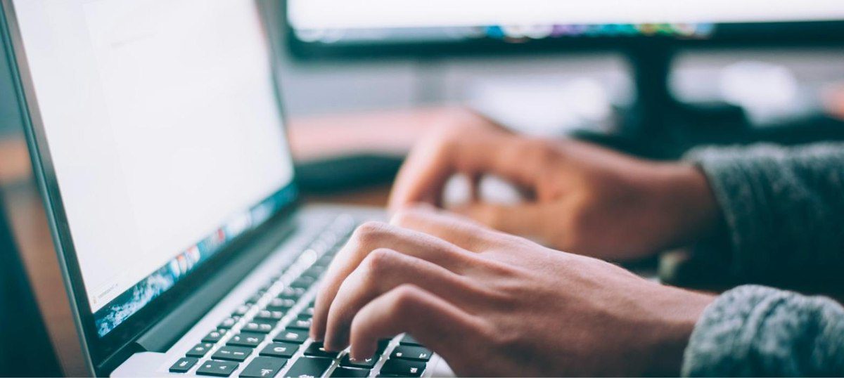 Content team using Jasper AI's brand voice feature to write marketing content on a laptop