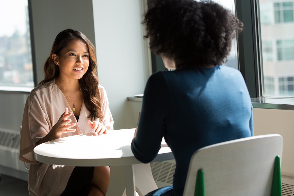 Two professionals in a job interview conversation after using an AI-optimized resume